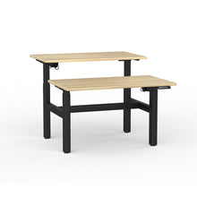 Load image into Gallery viewer, Double sided electric sit/stand desk with 2 desks at different heights to illustrate they work separately