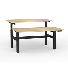 Load image into Gallery viewer, Double sided electric sit/stand desk with 2 desks at different heights to illustrate they work separately