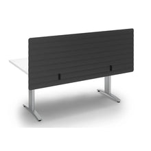 Load image into Gallery viewer, Dark grey acoustic modesty panel with wave design, mounted to the back of a desk sitting above and below the desk for extra privacy
